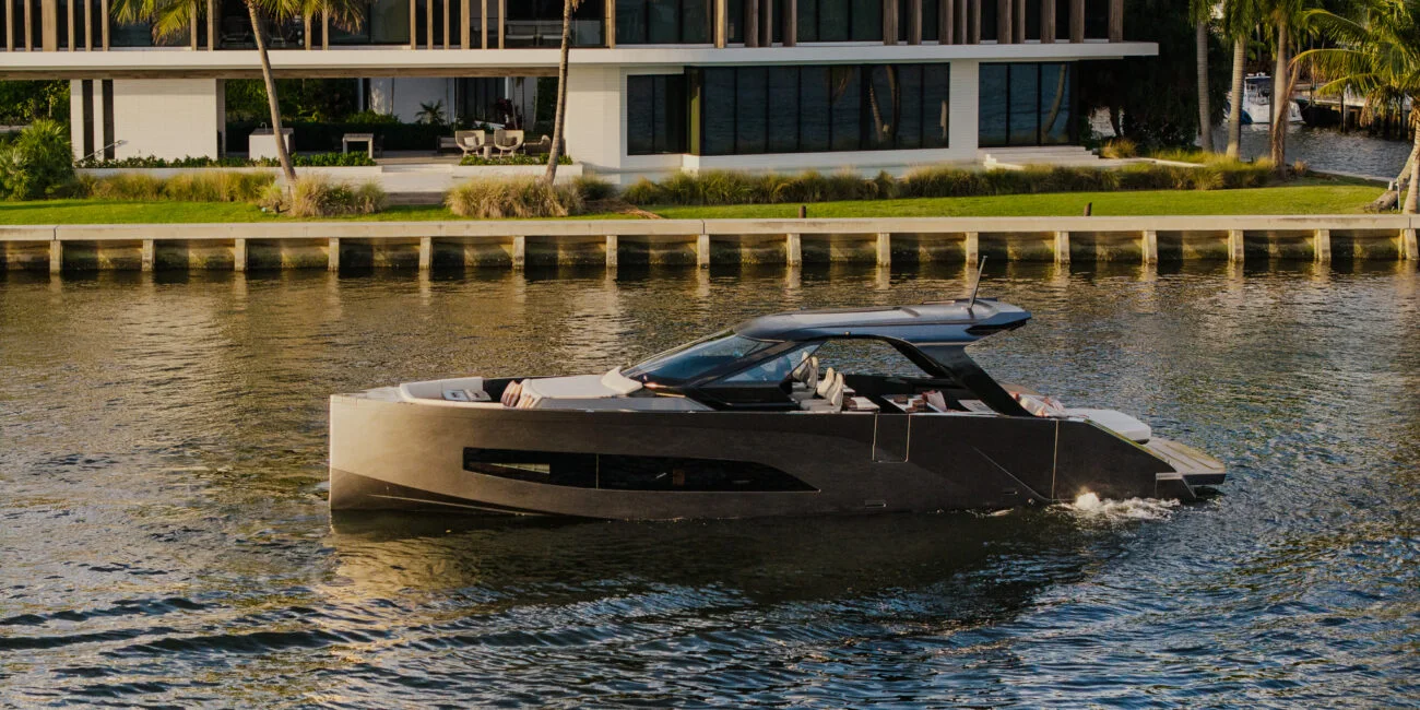 Manari 52 cruising beside a waterfront residence